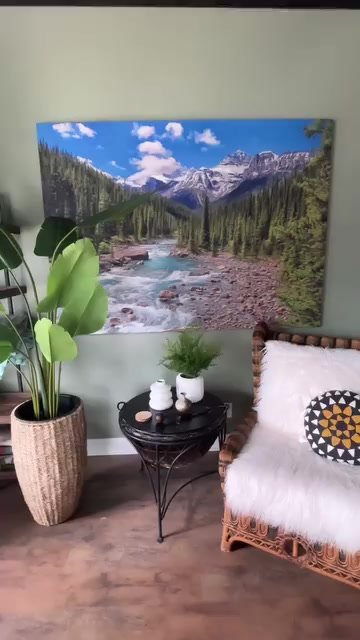 Finished oversized mountain and river artwork installed above a chair